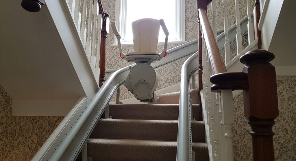 Curved stairlift installed on carpeted staircase in UK terraced house, folded seat position, natural indoor lighting, high detail realistic photography

